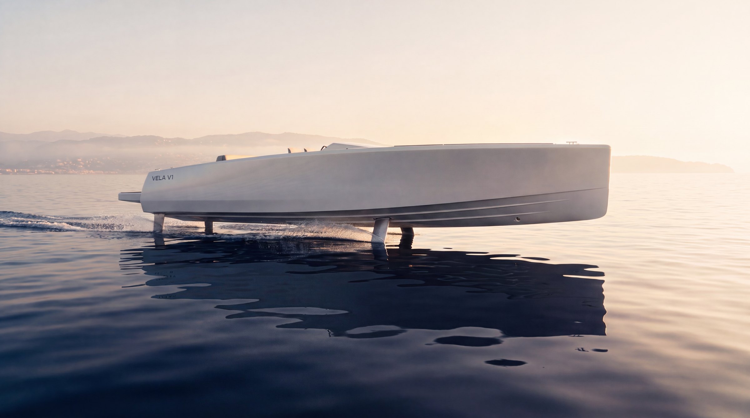 VELA V1 seen in profile, flying low over glassy water with the coastline behind